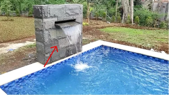 Area dinding waterfall kolam renang yang berpotensi berlumut.